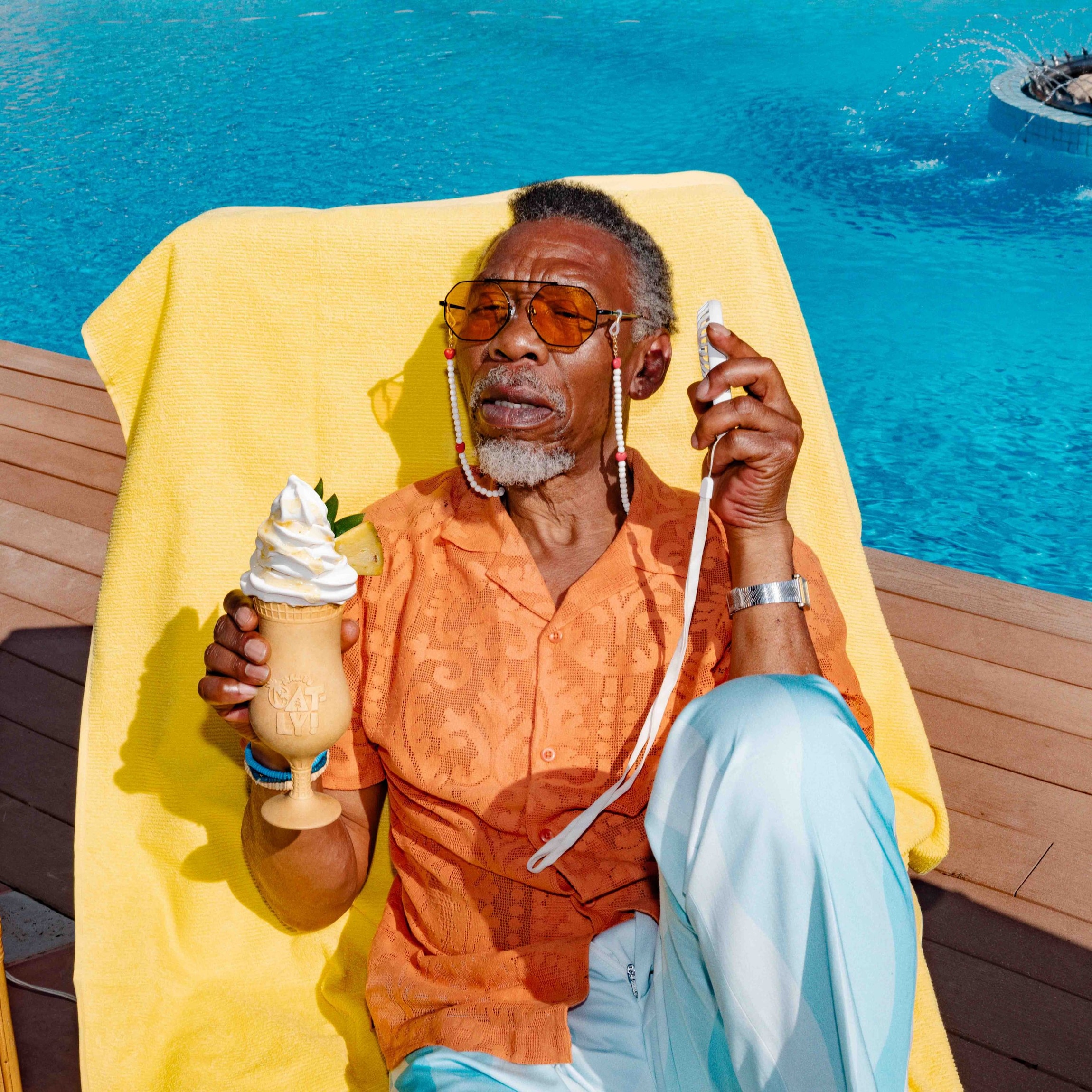 A man at the swimming pool with the Malibu x Oatly Oatlada soft serve