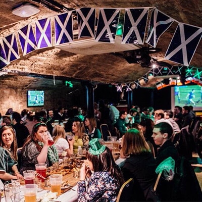 Three Sisters venue with people watching football and enjoying a drink